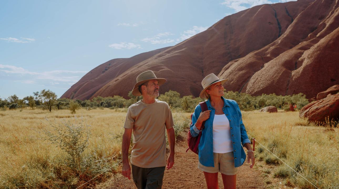 Couple walking around the base of Uluru