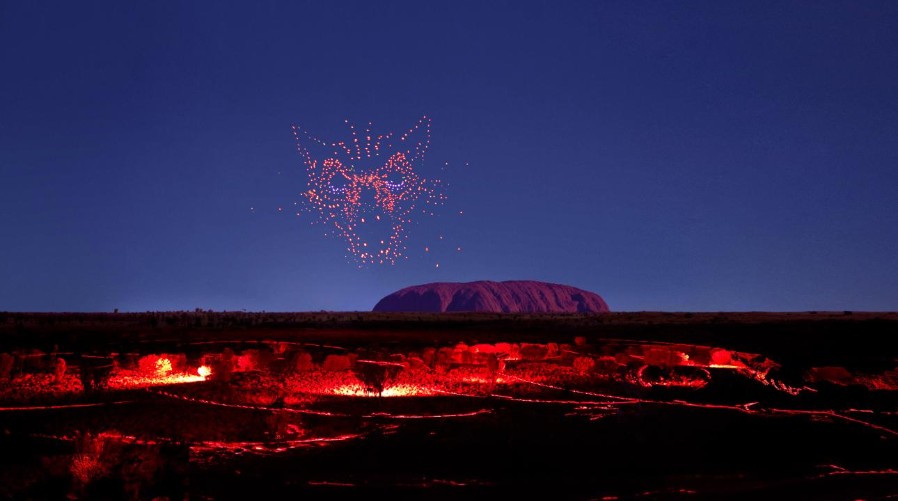 wintjiri wiru kurpany over the outback landscape in front of uluru