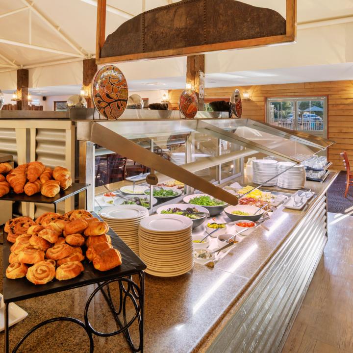 The breakfast buffet station with pastries, fruits and cereals in the middle of Bough House Restaurant