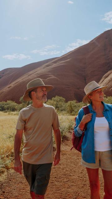 Couple walking around the base of Uluru